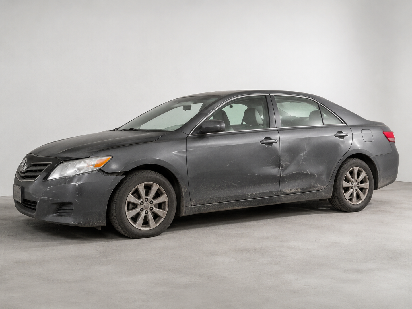 Vehicle before repair with side damage and scuffs